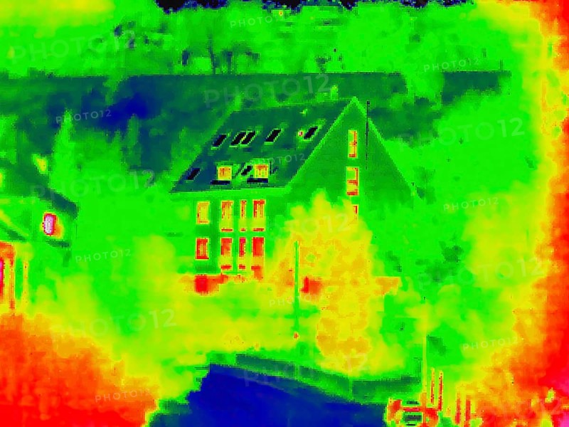 Apartment block, facade of a residential building with windows. Thermal image or thermography, symbol photo, interpolated. Germany