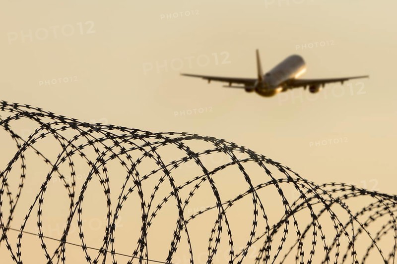 Symbolic image, deportation flights of illegal and delinquent migrants, passenger aircraft, airport, security fence, barbed wire, Germany, Europe