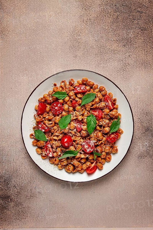 Tuscan pasta with smoked paprika and basil, parmesan cheese, Italian traditional cuisine