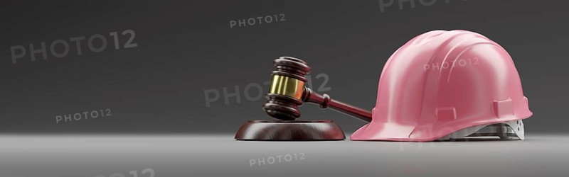 Pink hard hat and gavel on a gradated background banner with room for text or graphics