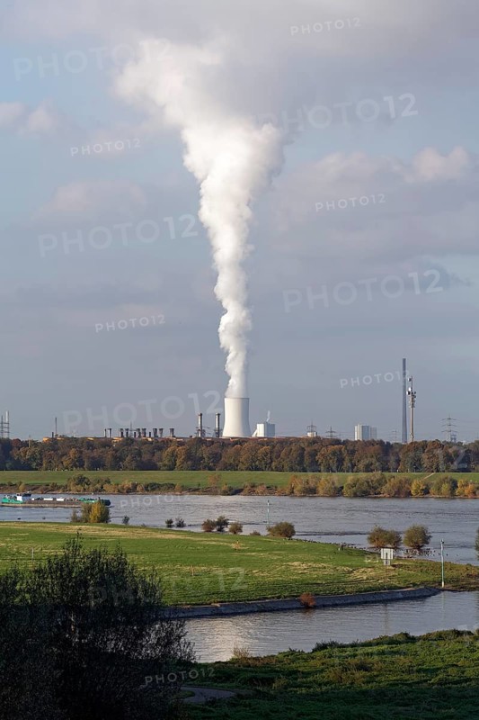 View of the green banks of the Rhine and white column of smoke from the cooling tower of the Thyssenkrupp steelworks, Duisburg-Laar, North Rhine-Westphalia, Germany, Europe