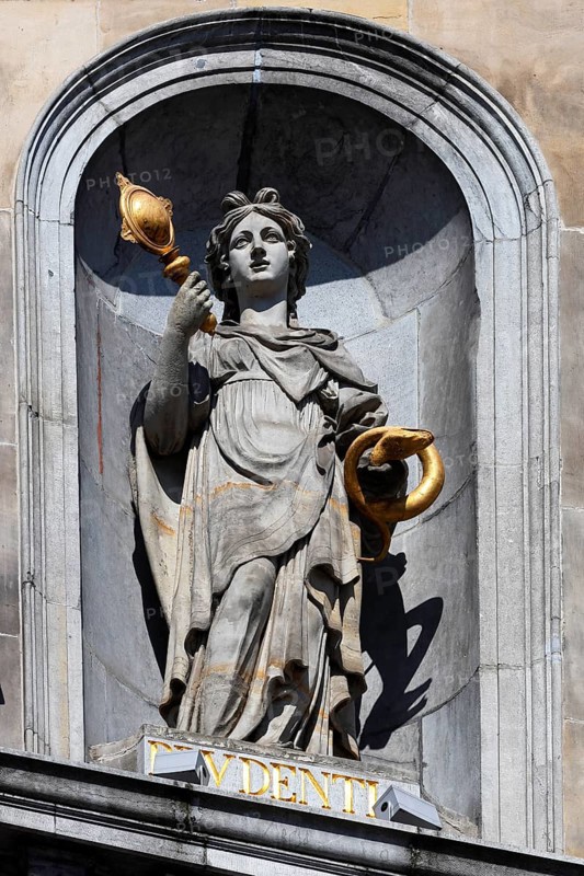 Historic City Hall Stadhuis on the Grote Markt, detailed view of allegorical statue of Prudentia with mirror and snake coiling around her hand on the façade, UNESCO World Heritage Site, Antwerp, Belgium, Europe