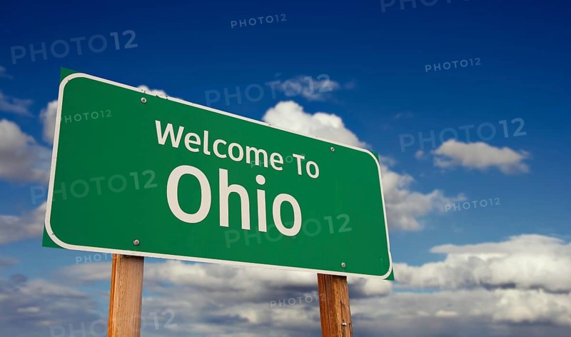 Welcome to ohio green road sign over blue sky with some clouds