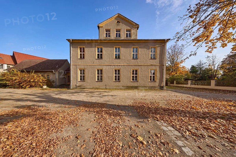 Two-storey building with pointed roof and dormer, autumnal trees and foliage, Schulplatz, Mühlberg Elbe, Elbe-Elster district, Brandenburg, Germany, Europe