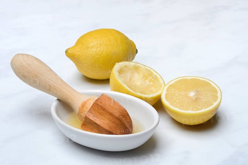 Lemons and lemon squeezer, squeezed lemon and lemon juice