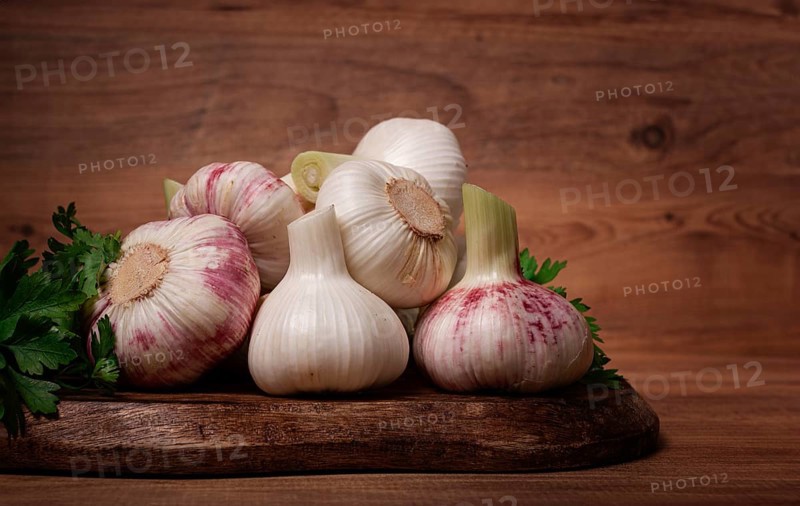 Fresh young garlic, white and purple color, on a wooden table, no people