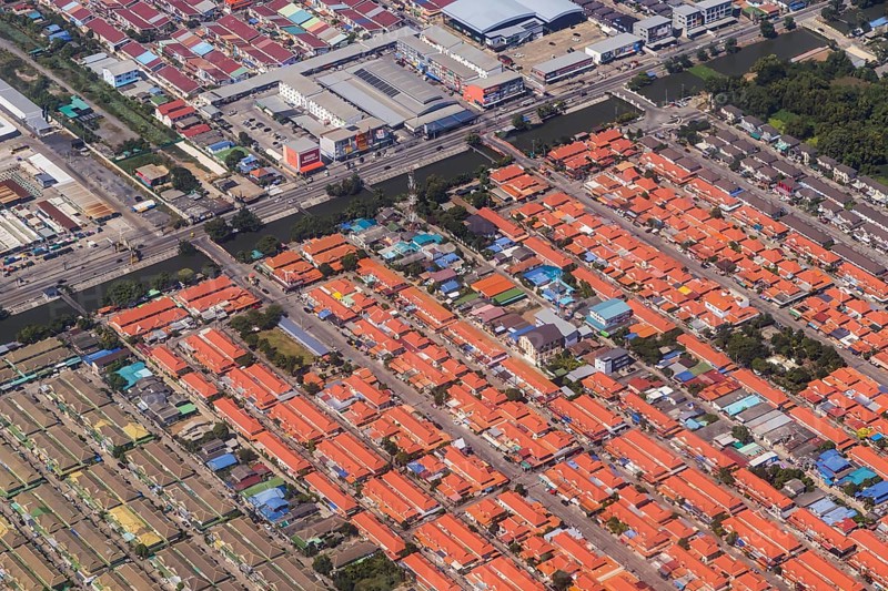 Retort city in the north-east of Bangkok. Standardised houses stand close together on the straight streets of a housing estate. Urban planning from the retort. Approaching Don Mueang Airport, Bangkok, Thailand, Asia