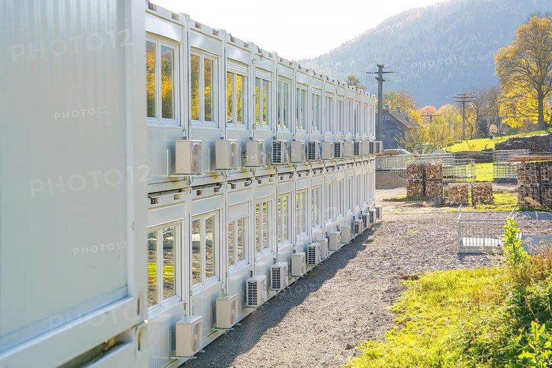 Rows of containers with air coolers in a sunny landscape, Beermiß refugee accommodation centre, Calmbach, Black Forest, Germany, Europe