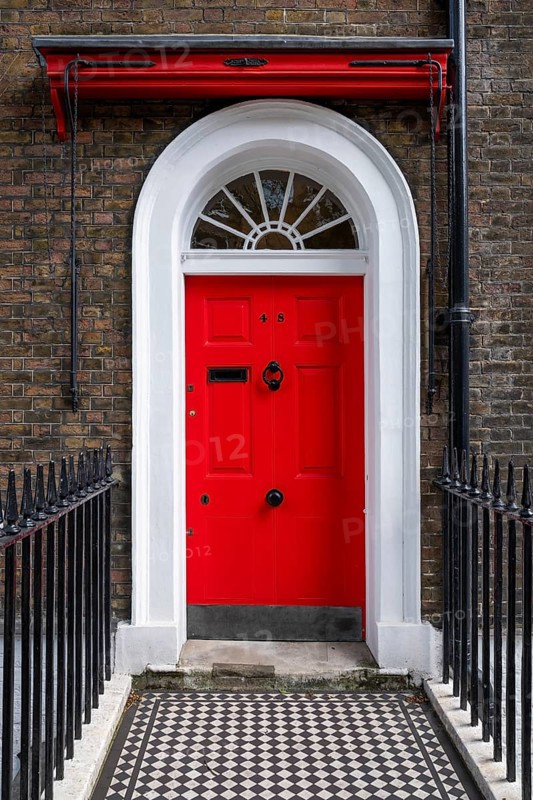Red entrance door in a brick building with a cast-iron fence, Charles Dickens Museum, 48-49 Doughty Street, Holborn, London Borough of Camden, England, United Kingdom, Europe