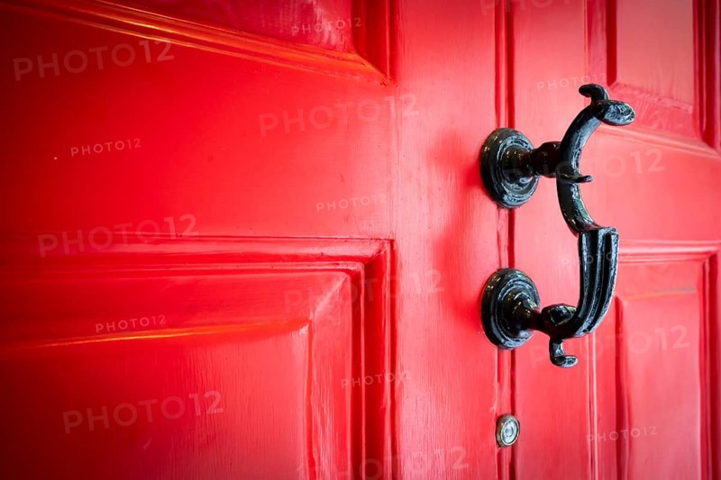 Close-up of a black door knocker on a red door, entrance to the Charles Dickens Museum, 48-49 Doughty Street, Holborn, London Borough of Camden, England, United Kingdom, Europe