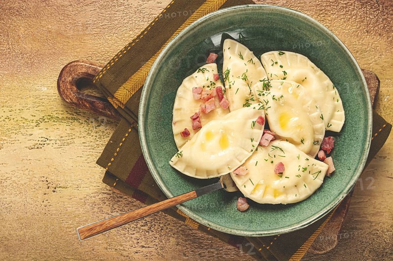 Dumplings, with fried prosciutto, a traditional dish of Polish cuisine, dumplings, top view, close-up, without people