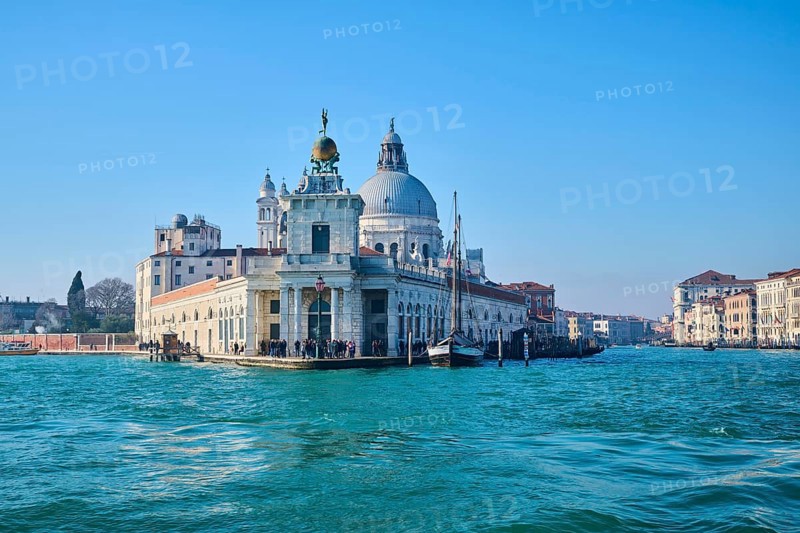 View from the water on church 'Basilica di Santa Maria della Salute' and 'Canal Grande' in Venice on a sunny day in winter, Italy, Europe