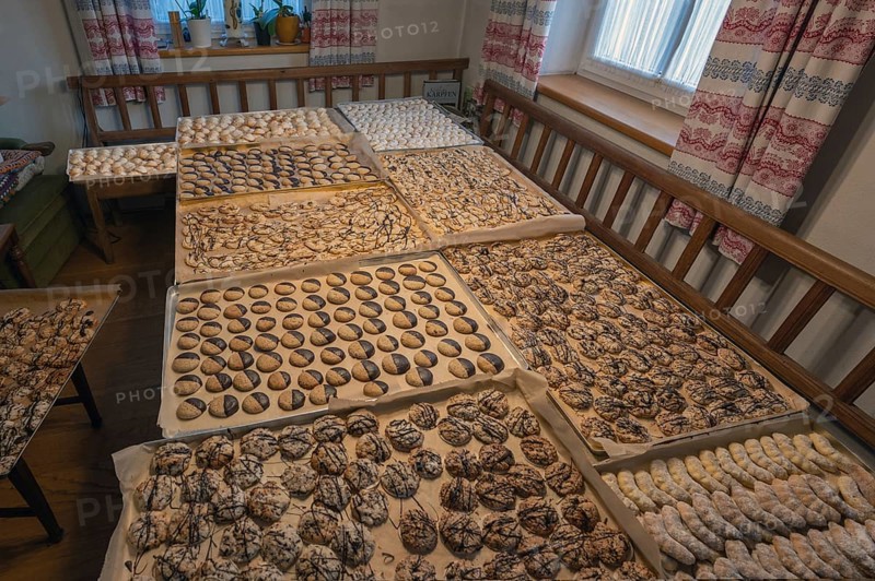 Ready-baked biscuits arranged on baking trays on the table, Bavaria, Germanybd