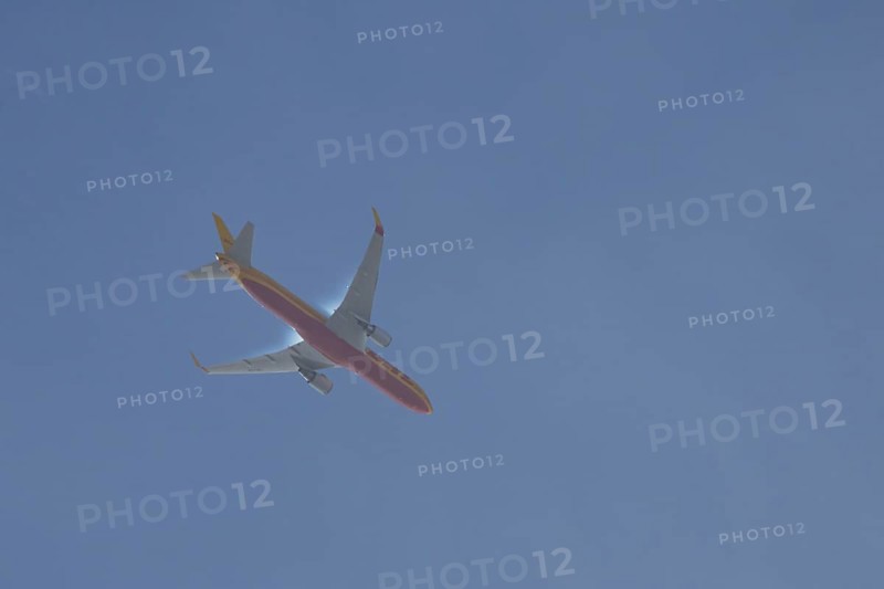 Boeing 767 jet aircraft of DHL airlines flying in a blue sky, England, United Kingdom, Europe