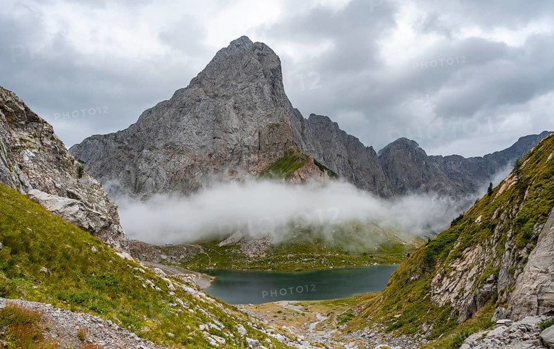 Mountain lake Wolayersee and rocky cloudy mountains, Carnic Alps, Carnic High Trail, Carinthia, Austria, Europe