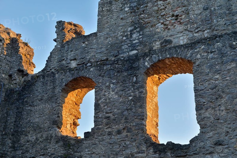 Old stone ruins with two window openings, illuminated by the warm light of the golden hour, Wolfstein castle ruins, Neumarkt in der Upper Palatinate