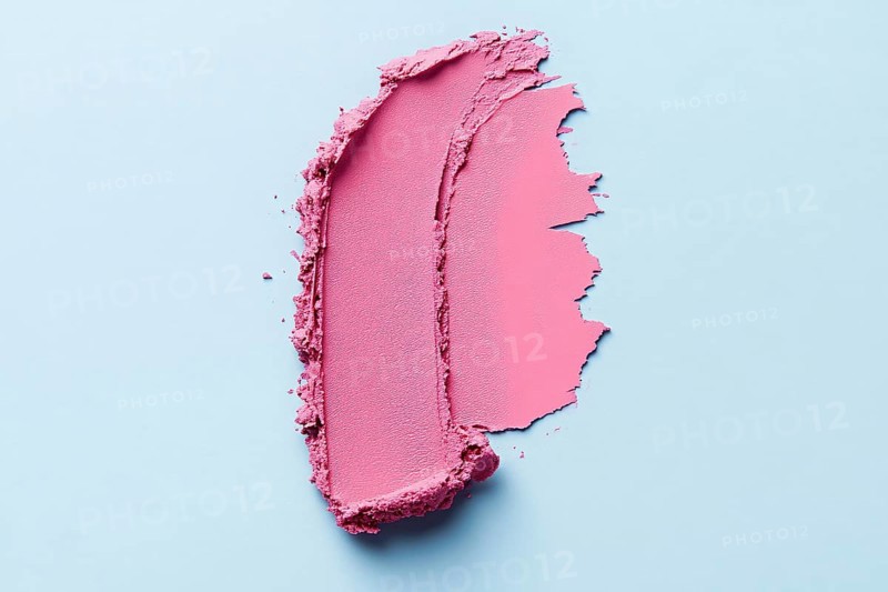 Pink lipstick color swatch smudge on light blue background. Generative Ai, AI generated
