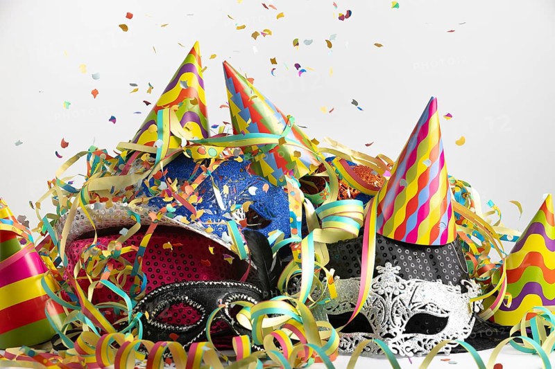 Colourful party hats with confetti and streamers in a lively party setting, carnival