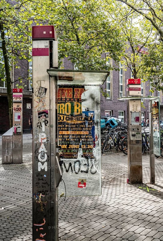 Old, no longer functional public telephones, of Telekom, destroyed, dirty, at the main railway station in Düsseldorf, North Rhine-Westphalia, Germany, Europe