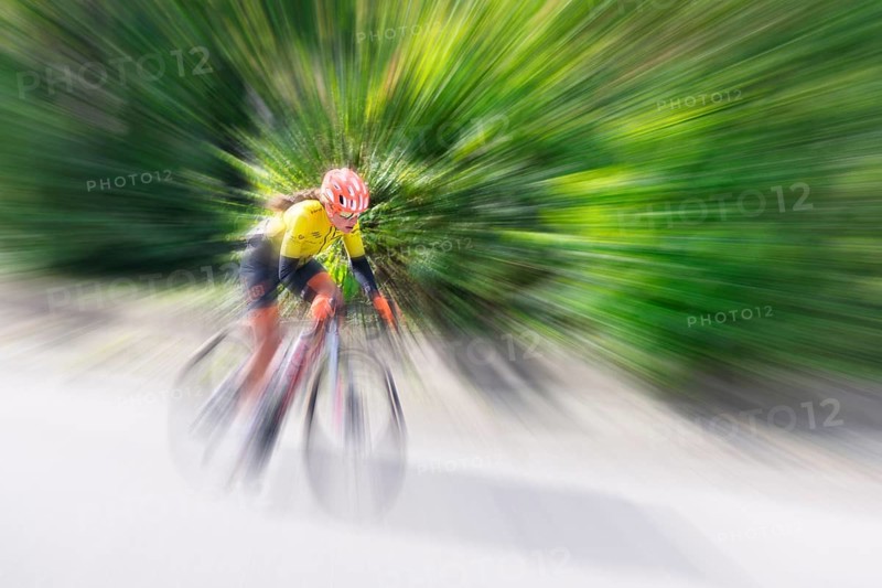 Cyclist in sportswear and helmet riding at high speed on a road, race, the motion blur emphasises the speed, Stuttgart, Baden-Württemberg, Germany, Europe