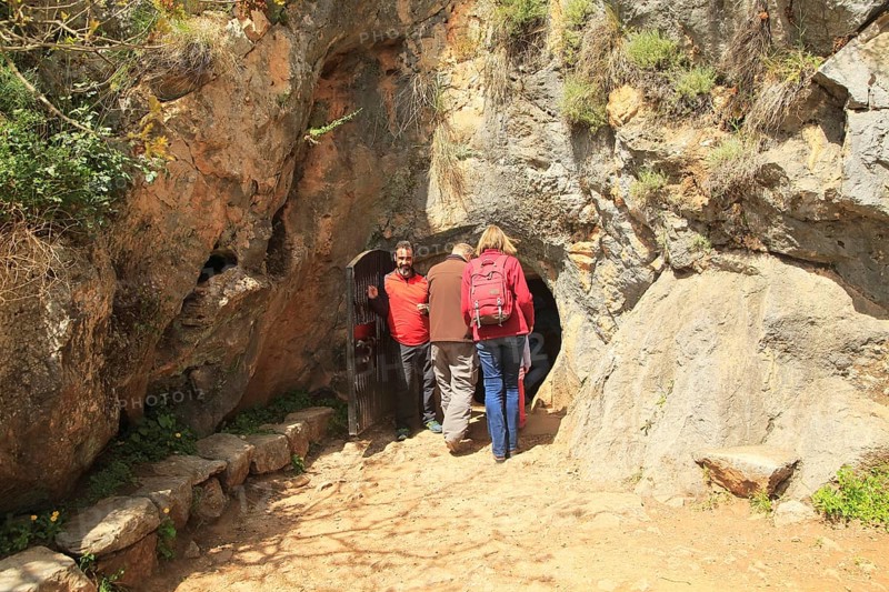 People entering the cave entrance, Cueva de la Pileta, near Ronda, Malaga province, southern Spain