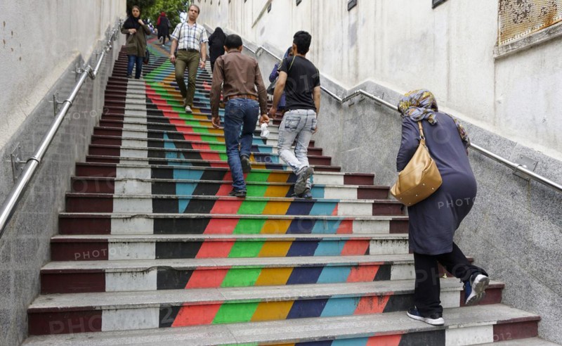 People walk down a painted staircase. The city of Tehran is changing the image of the city through art objects in public spaces, 21/05/2016