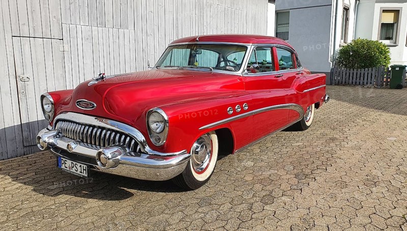 A shiny red classic car with chrome details parked in front of a white garage door, classic car, Buick Eight, Ilsede, Peine district, Lower Saxony, Germany, Europe