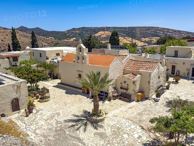 View of courtyard courtyard with Phoenix theophrasti of Odigitria Monastery in the centre two-aisled church Monastery church with annexes dedicated to the Assumption of the Virgin Mary and the Apostles Peter and Paul, Unesco Site Orthodox Greek Orthodox Monastery of Moni Odigitria, Festos, Crete, Greece, Europe