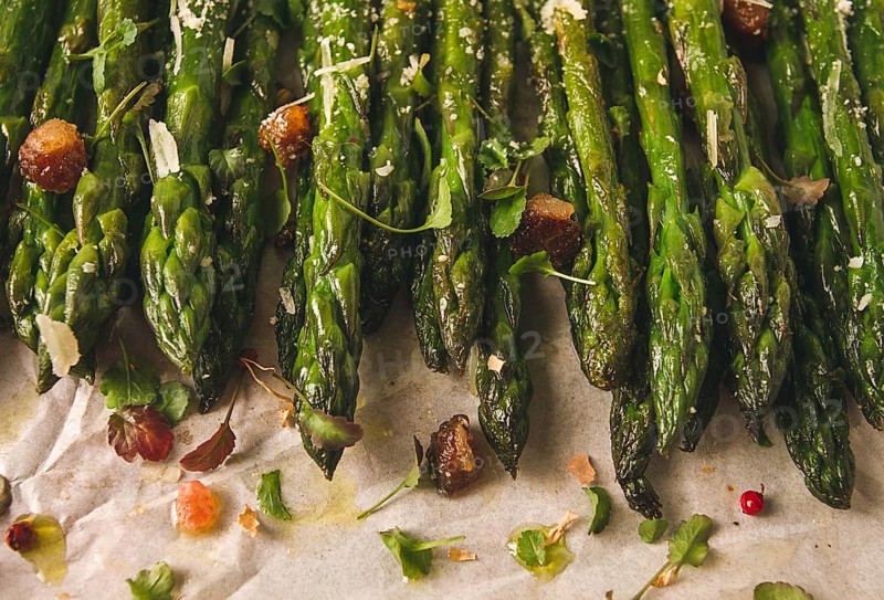 Grilled asparagus, with spices and herbs, parmesan cheese, on a white background, top view, rustic, no people