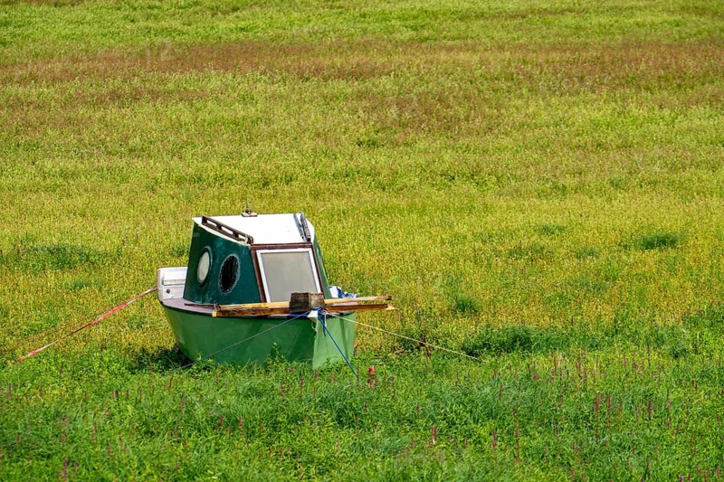 The Edersee, near Waldeck, the third largest reservoir in Germany, currently has only just under 13% of its normal level, the lake was last full in May 2022, dried out due to lack of rain, stranded fishing boat, rowing boat, the lake shore and the lake bottom is overgrown with fresh grass, Hesse, Germany, Europe