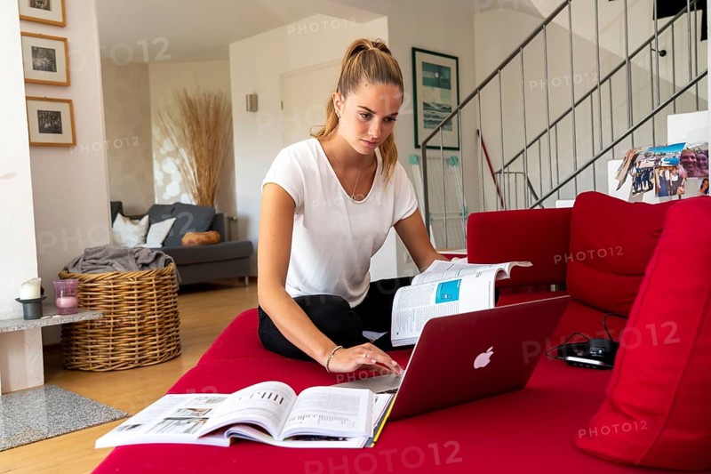 Young student learns at home, online, on her notebook