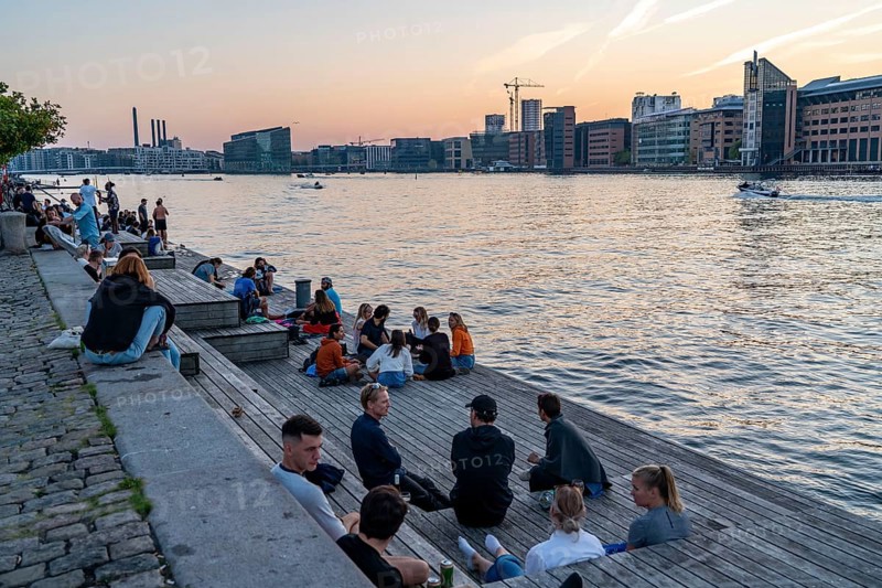 Summer evening in Copenhagen, at the harbour, Islands Brygge, people celebrating, eating, drinking, relaxing at the harbour shore, Denmark, Europe