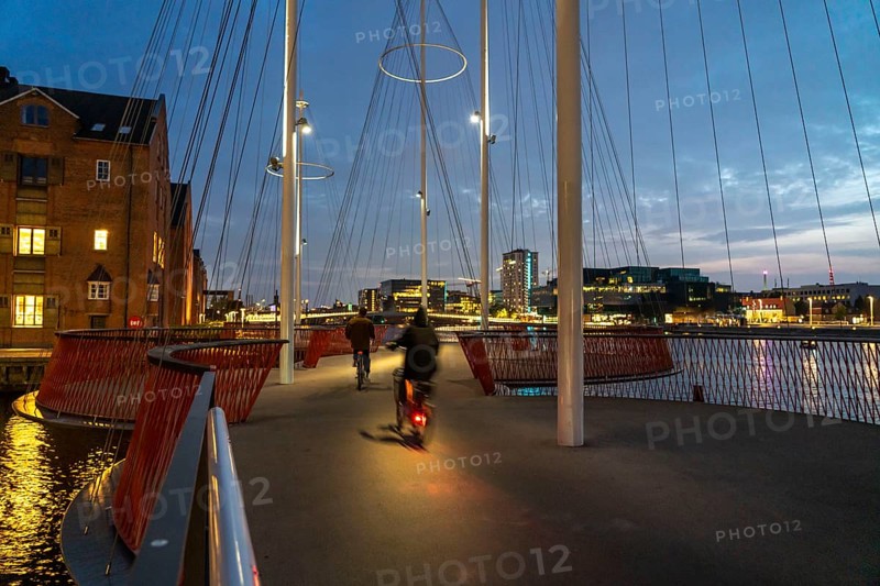 Cyclists on the Cirkelbroen cycle and pedestrian bridge, over the harbour, in the Christianshavens district, Copenhagen is considered the cycling capital of the world, 45 % of the population travel by bike, Denmark, Europe