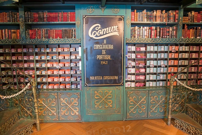 Classic shop with shelves displaying books and colourful preserves in an antique style, decorative wooden details, sardine tins, tinned sardines, Óbidos, Obidos, Oeste, Centro, Estremadura, Portugal, Europe