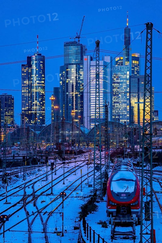 Railway tracks in front of the main railway station in Frankfurt am Main, skyline of skyscrapers in the Cit, winter, snow, dusk, Hesse, North Rhine-Westphalia