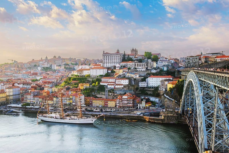 View of Porto city and Douro river and Dom Luis bridge I from famous tourist viewpoint Miradouro do Jardim do Morro on sunset. Porto, Vila Nova de Gaia, Portugal, Europe