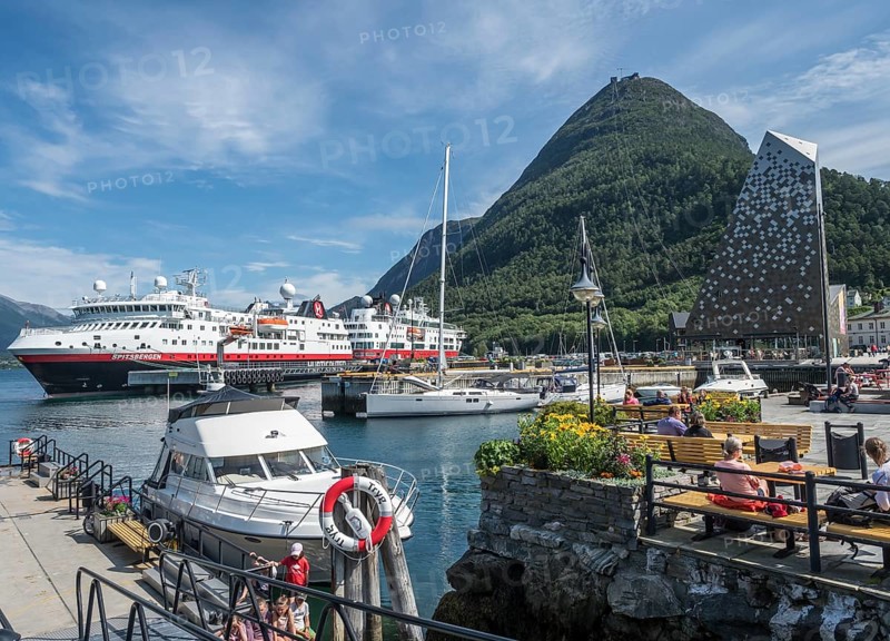 Andalsnes harbour, sailing boats and Hurtigruten ship anchor in the harbor on a sunny summer day. Hurtigruten ship are out of service due to corona. Andalsnes, More og Romsdal, Norway, Europe