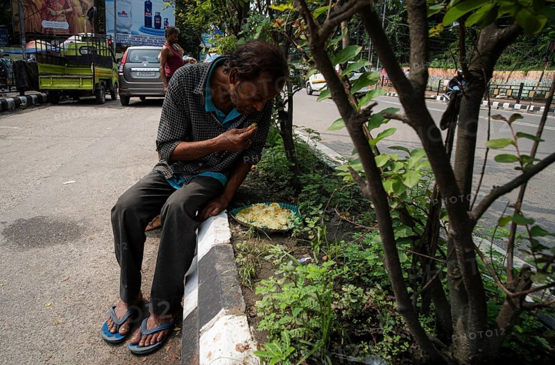 Homeless people eats food being distributed by volunteers along the roadside, on October 11, 2024 in Guwahati, India. Poverty and hunger remain significant challenges in India, despite the country's rapid economic growth in recent decades