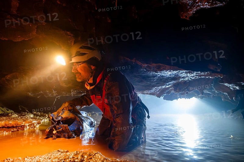 Speleologist crosses an underground lake, Advent Cave, Schneizlreuth, Berchtesgadener Land, Upper Bavaria, Bavaria, Germany, Europe