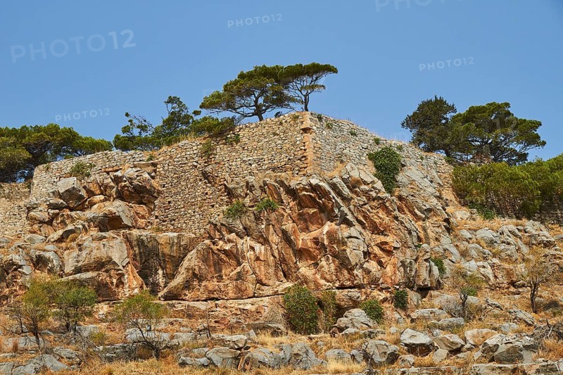 Rocky landscape with ancient wall remains surrounded by trees under a clear sky, Venetian Sea Fortress, Leper Island, Spinalonga, Elounda Bay, Mirabello Bay, East Crete, Crete, Greek Islands, Greece, Europe