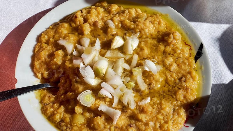 Fava, A plate of a traditional dish, chunky and garnished with onions, served on white crockery, Drakona, Slowfood, Restaurant Dounias, Lefka Ori, White Mountains, Massif, West, Crete, Greece, Europe