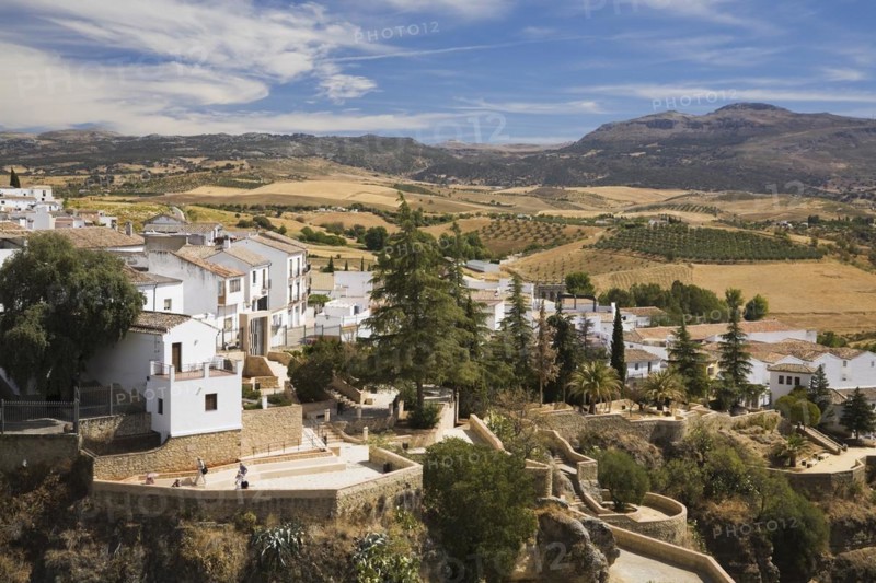 High angle view of residential buildings and valley with agricultural lands and mountains, Ronda, Spain, Europe