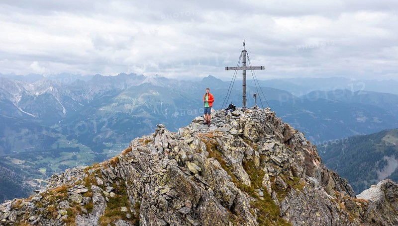 Aerial view, hiker on the Raudenspitze with summit cross, Carnic High Trail, Carnic Main Ridge, Carnic Alps, Carinthia, Austria, Europe