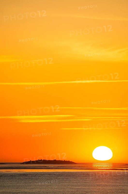 Picturesque, golden, magnificently beautiful sunset over the sea, island Langlütjen II far away, sun egg-shaped on the horizon, orange glowing cloudless sky, wide sea in soft colours, calm atmosphere, radiant light mood, mouth of the Weser into the North Sea, Outer Weser, Bremerhaven, Land Bremen, Germany Bremerhaven, Land Bremen, Germany, Europe
