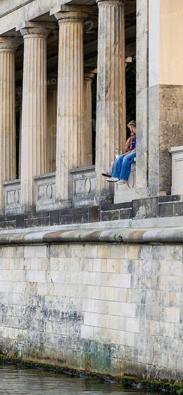 Young couple among the columns of the Neues Museum, Berlin, Germany, Europe