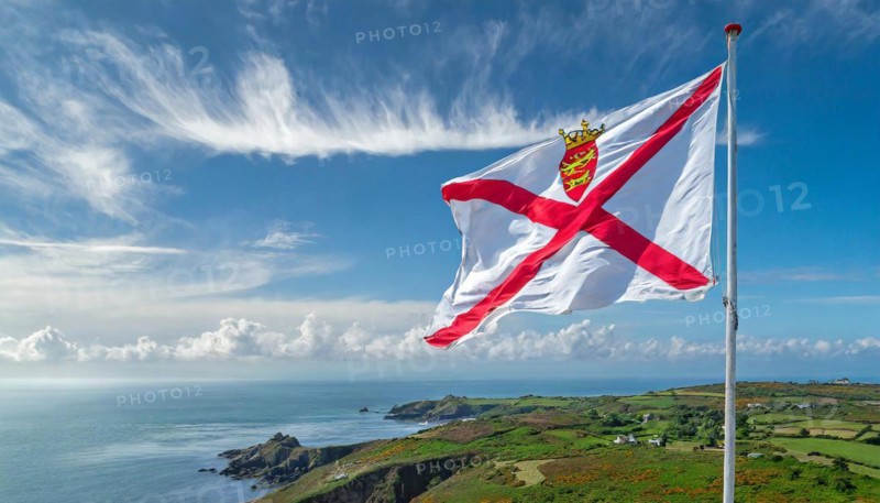 The flag of the Isle of Jersey, Great Britain flutters in the wind