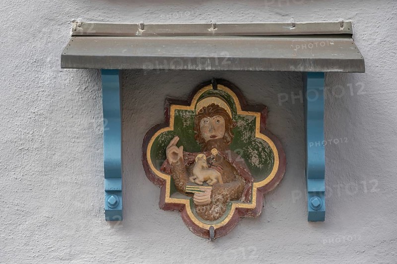 Fresco of St Agnes with a lamb, above a protective roof on a town house, Villingen-Schwenningen, Baden-Württemberg, Germany, Europe