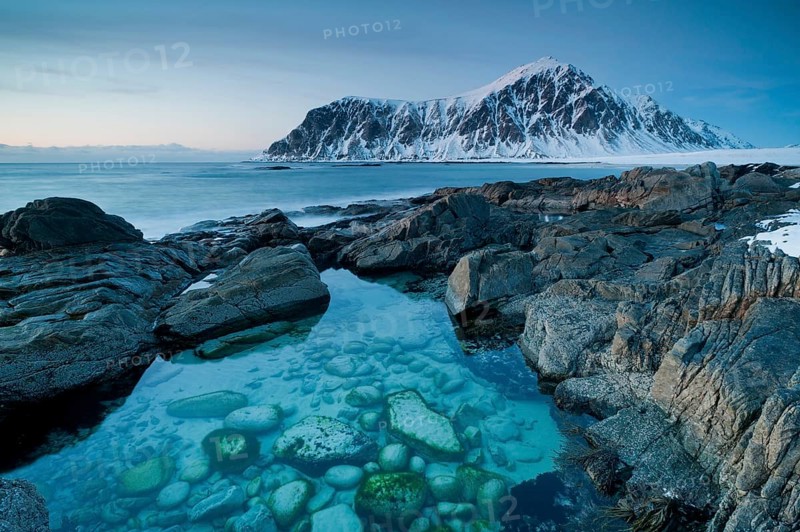 Long exposure, winter at Skagsanden, rocks washed over by the sea on the beach at Flakstad, Flakstadøy, Lofoten, Nordland, Norway, Europe