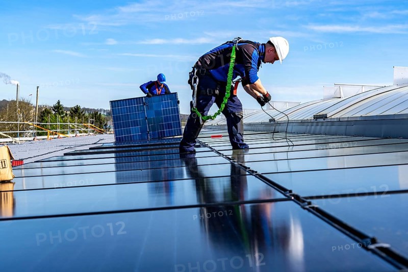 Installation of solar modules on the roof of a commercial enterprise, over 400 photovoltaic modules are installed on the roof, North Rhine-Westphalia, Germany, Europe