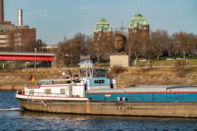 Echo of Poseidon, the 10 m high sculpture by Markus Lüpertz on Mercatorinsel, erected for the 300th anniversary of the harbour, 2016, in the background the bridge towers in Ruhrort, the Friedrich Ebert Bridge over the Rhine, Duisburg, North Rhine-Westphalia, Germany, Europe